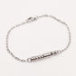 A silver chain bracelet with a morse code message in stainless steel beads clasp and a lobster clasp, displayed on a clean off-white background.