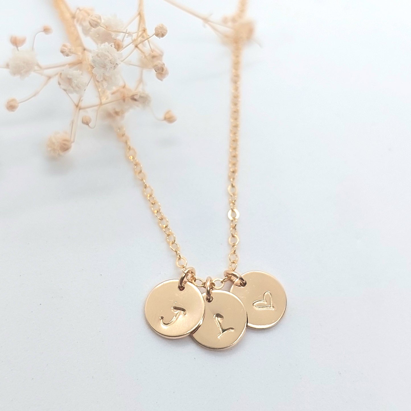 Small disc necklace with 3 small discs with initial and heart  hand stamped onto it. Personalised jewellery NZ. Sterling Silver, Gold fill and Rose Gold Fill. Personalised gift NZ. Hand stamped jewellery NZ. Custom made gift